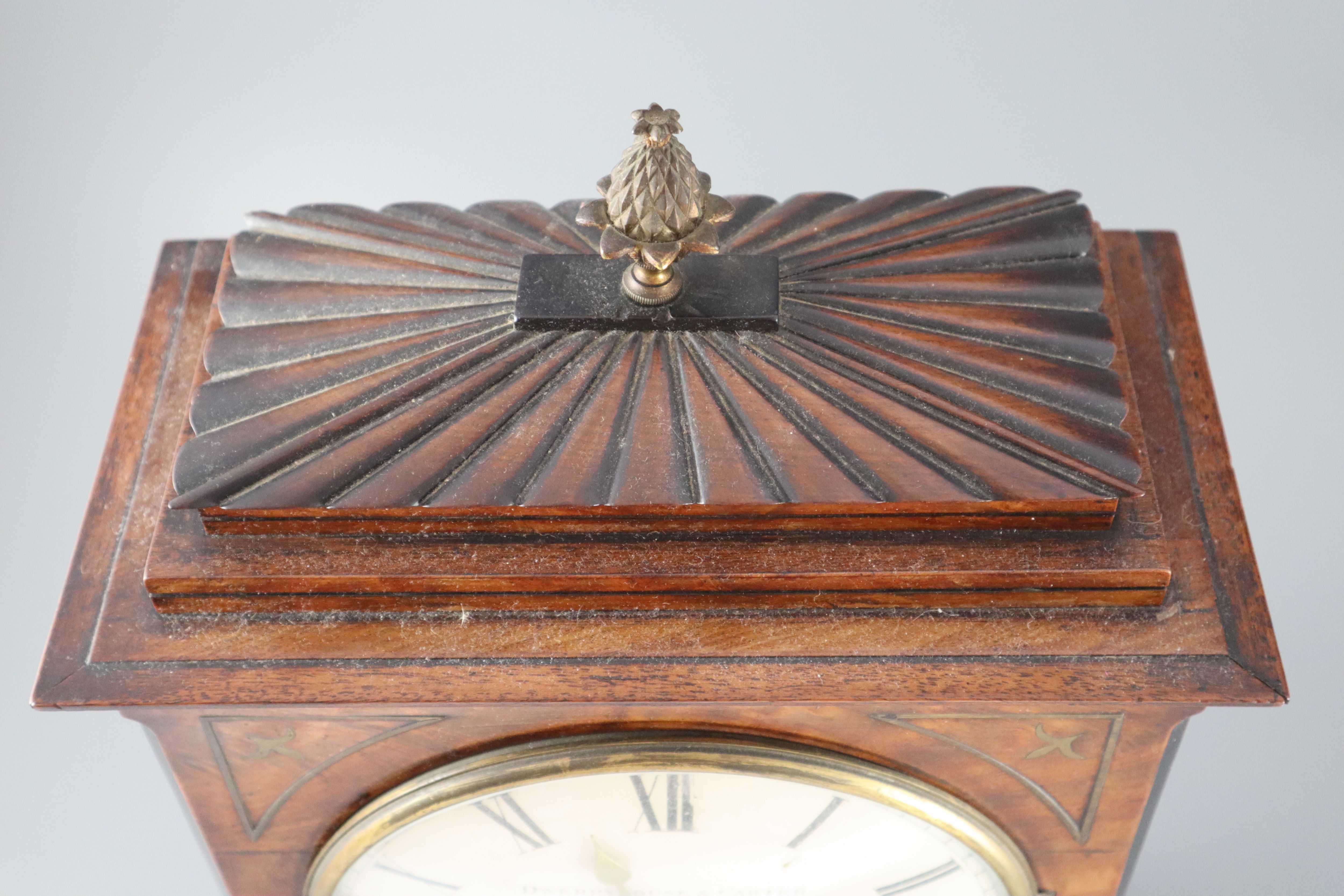 Dwerryhouse & Carter of London. A Regency brass inset mahogany mantel clock, height 19.5in.